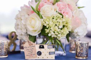 Wedding table bouquet and camera for guests