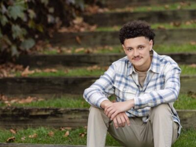 high school senior boy sitting on grass stairs