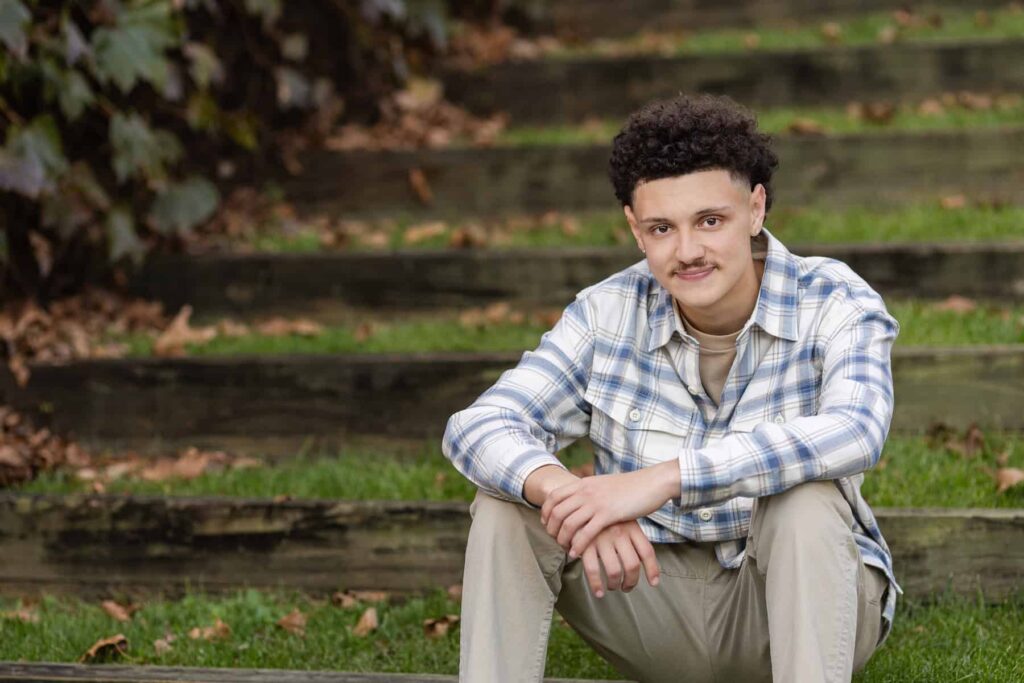 high school senior boy sitting on grass stairs