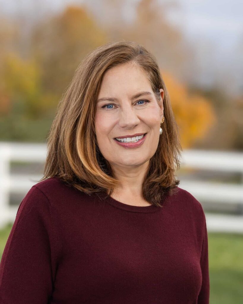 Headshot of brunette woman outdoors